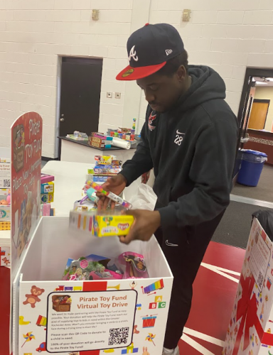 A student sorts toys from the toy drive