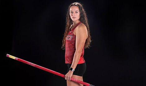 Brynn King poses with pole vault pole