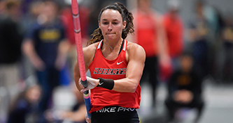 Brynn runs while holding pole vault pole