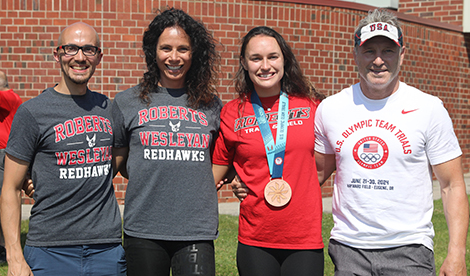 Brynn and the pole vault coaches smile