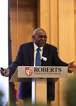 Dr. Hayles speaks at a podium