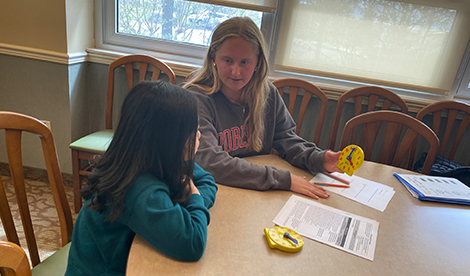 A Roberts student teaches an elementary student