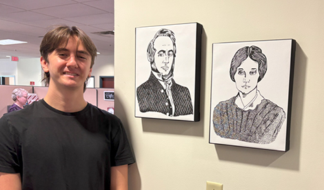 Eliott smiles with his art of BT and Ellen Roberts