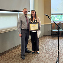 Emily Robinson smiles while receiving award