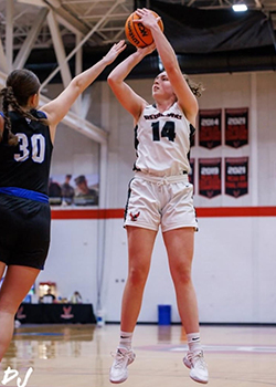 Grace shoots basketball during a game