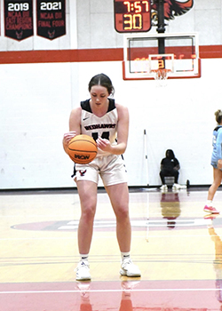 Grace dribbles a basketball