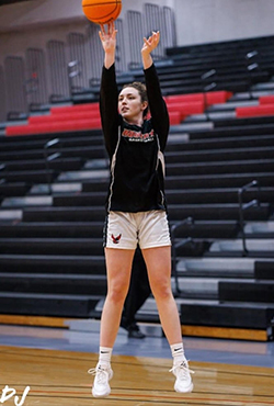 Grace shoots a basketball