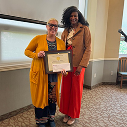 Laura Falco smiles while receiving award