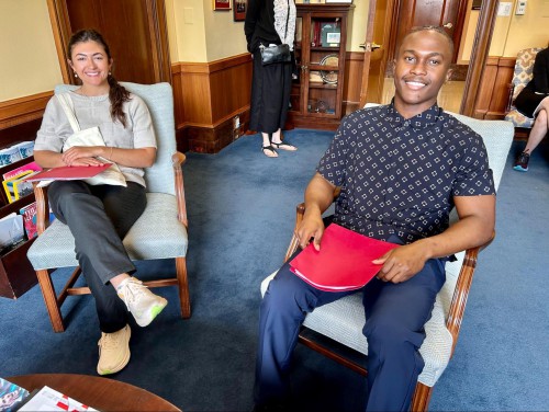 Brooke Tangelder and Marc sit in chairs while smiling