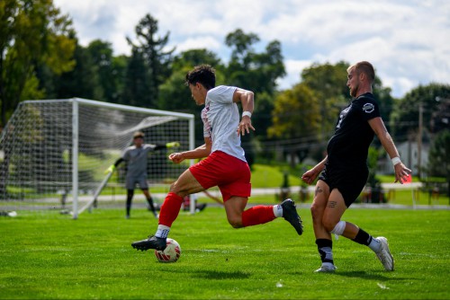 Noah kicks the soccer ball during a game
