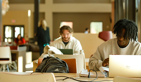 Students study behind laptops