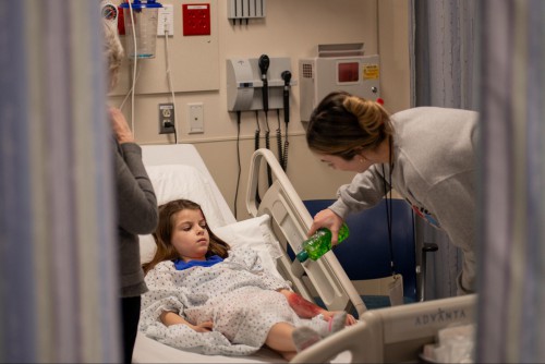 A nurse provides care to a patient