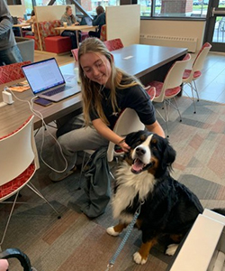 Young woman pets dog