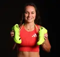 Brynn King smiles with adidas shoes around her neck