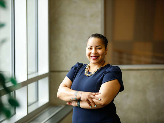 A confident graduate student smiling