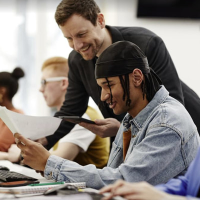 2 men smile at paper