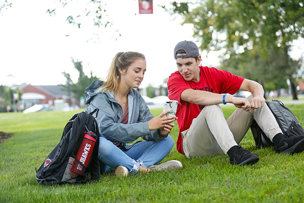 Two students sitting at Roberts Wesleyan University