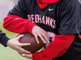 A female student grabbing a football