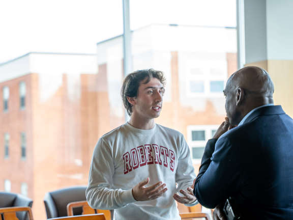 a male student speaking with Rupert Hayles