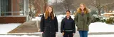 Students stand on campus in the snow